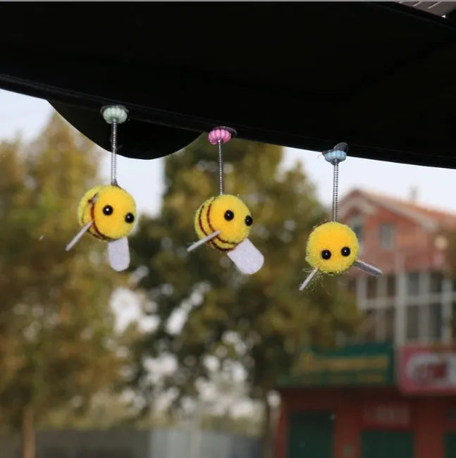 Swing spring bee car decoration made from soft fur ball, showing cartoon bee shape.