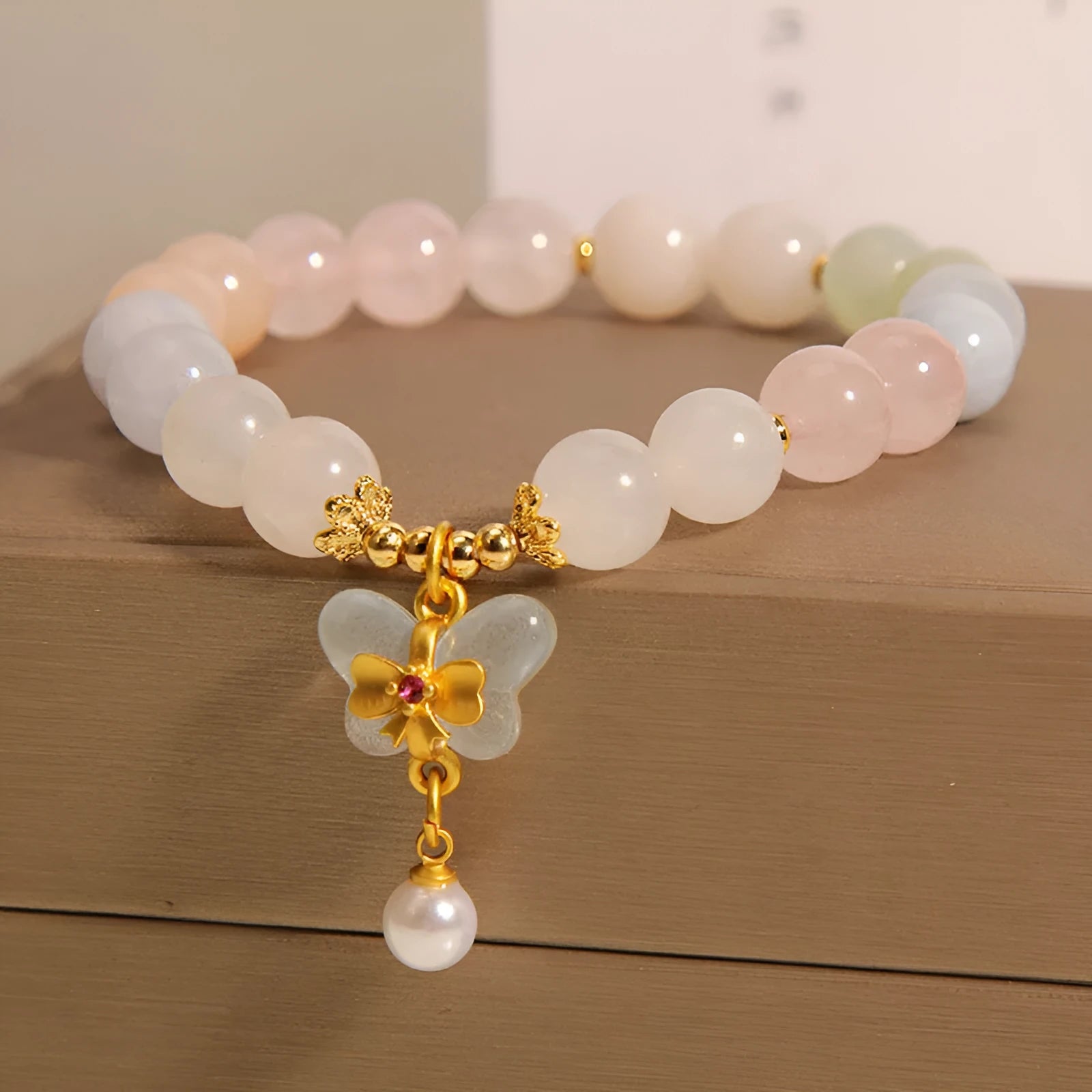 Crystal bracelet with natural Morganite butterfly pendant charm in candy colours on adjustable band