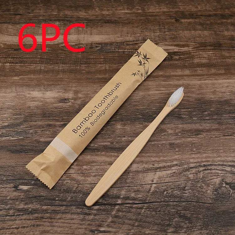 Set of ten bamboo toothbrushes with charcoal-infused bristles in assorted colours on a white background.