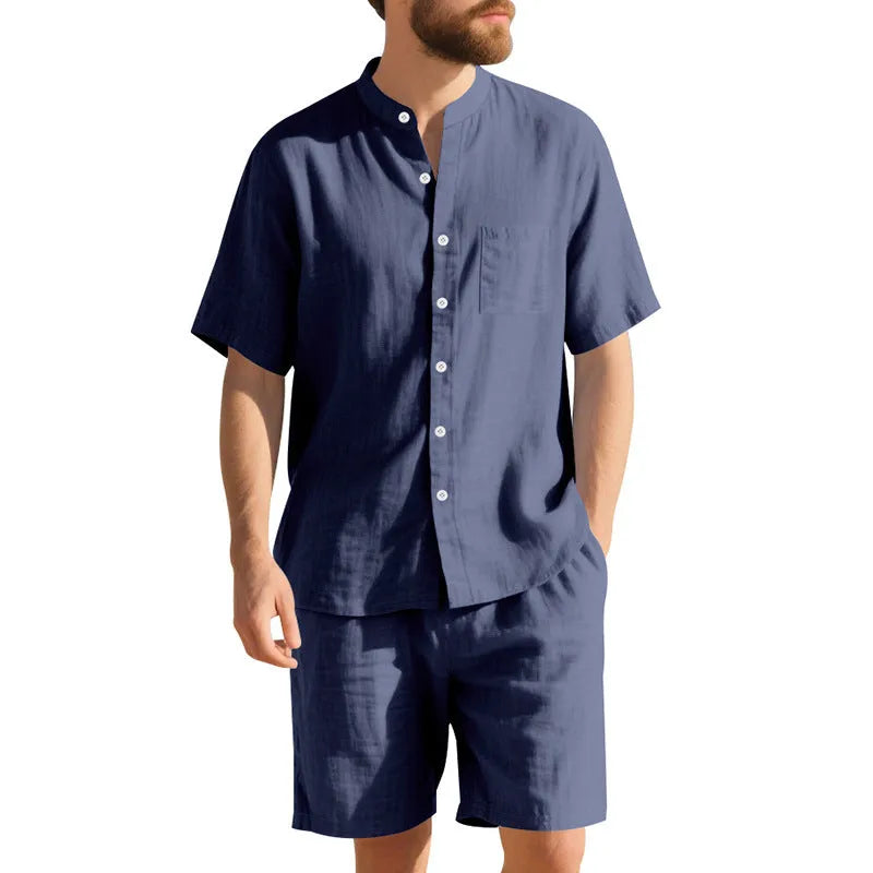 Man wearing a light blue short-sleeve linen blend suit jacket and matching shorts with a Henry collar.