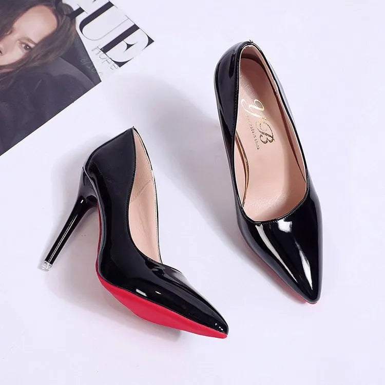 Women's black pointed toe stiletto pumps with a low-cut vamp and thin high heel on a white background.