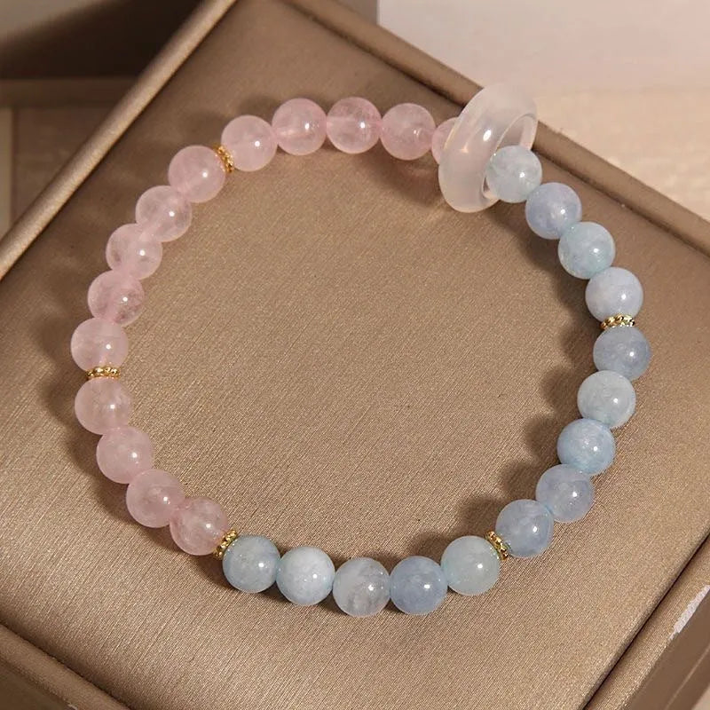 Aquamarine crystal bracelet with mixed materials including pink beads, white pearls, and peach blossom elements