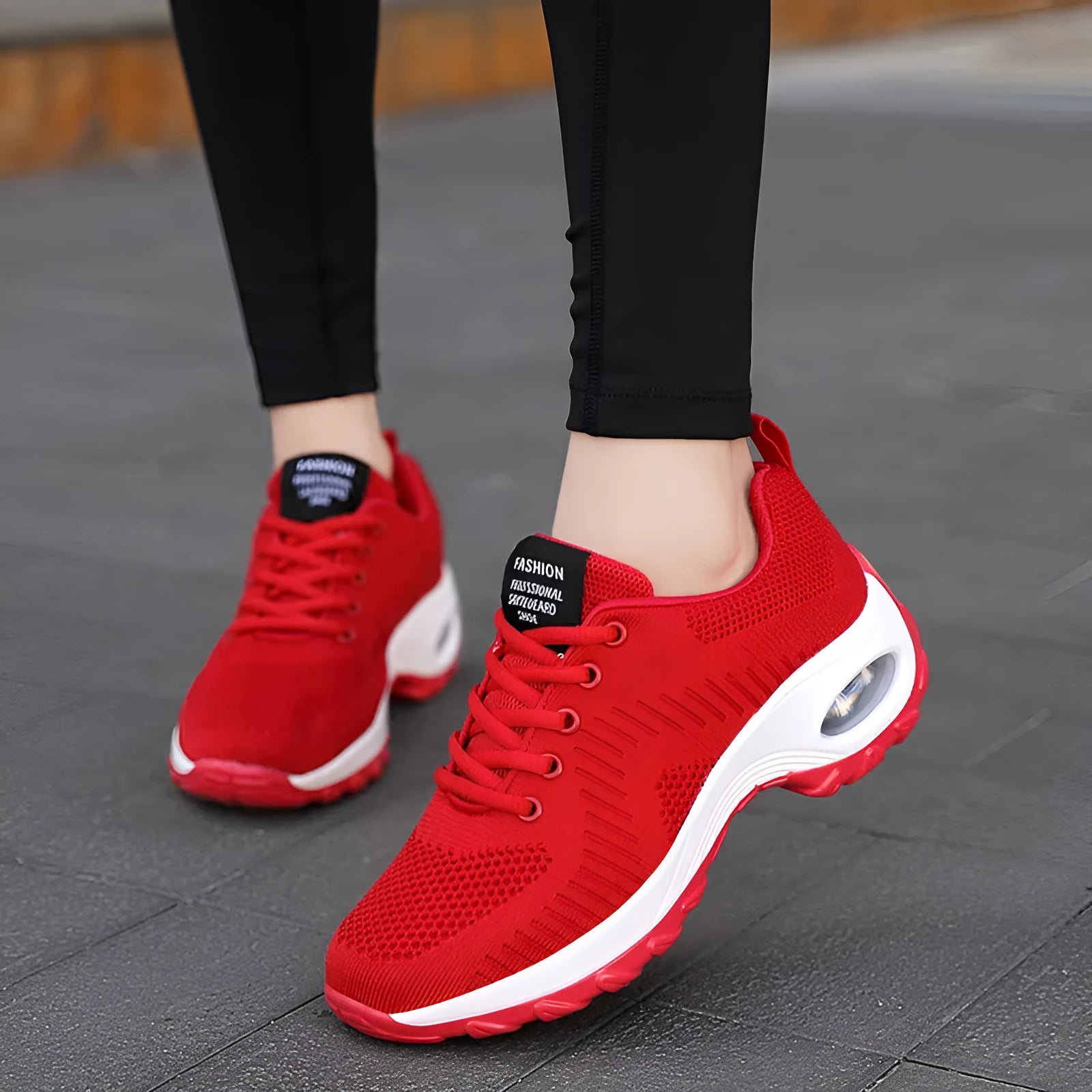 Red and black women's low-top mesh sneakers with round toe and front lace-up closure.