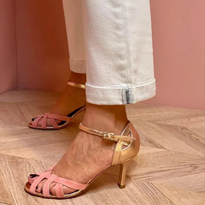 Pink peep-toe sandal with over-the-knee sock and silver buckle closure on a rubber sole.