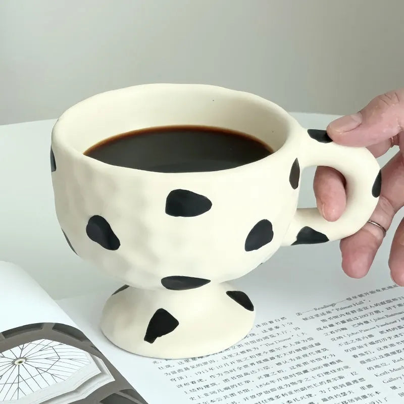 Hand-pinched irregular shaped ceramic mug in solid colour with modern simplicity design