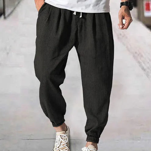 Men's casual cotton trousers with banded ankles in light green colour showing loose fit summer style