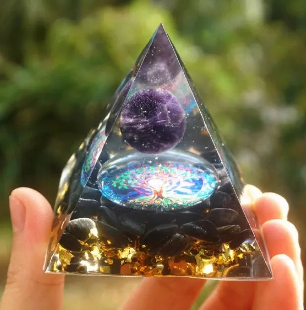 Clear epoxy resin pyramid ornament with embedded coloured crystal gravel inside, measuring 6cm.