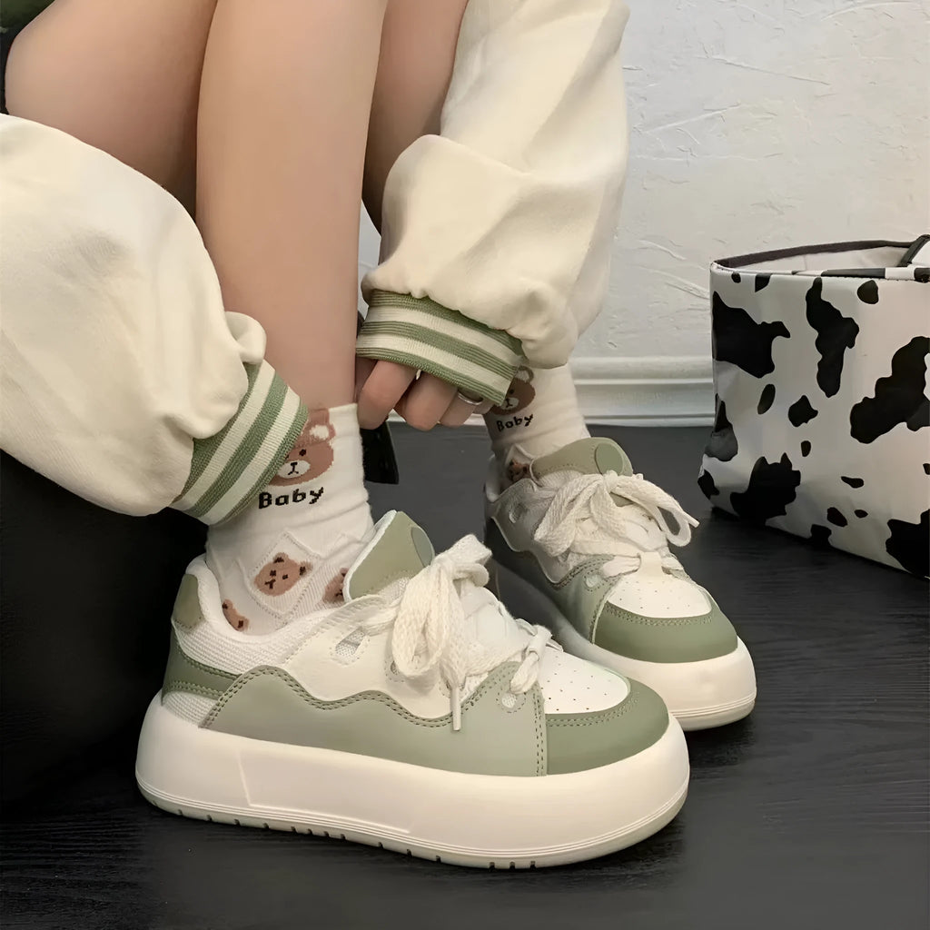 Women's green casual shoes with mesh upper, flat heel, and round toe design