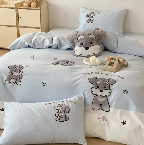 Schnauzer dog cartoon embroidery design on a light-coloured cotton quilt cover and pillowcase from a four-piece bedding set.