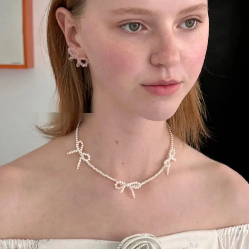 White sweet bow pearl necklace for women on an adjustable 31cm-40cm chain.