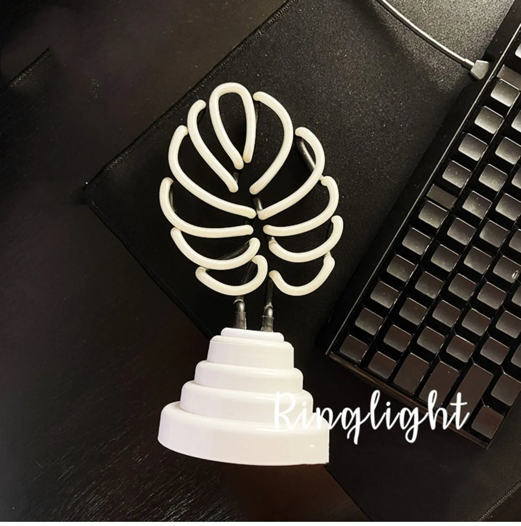 Minimalist bamboo-shaped white and green desktop lamp with USB cable in two size options.
