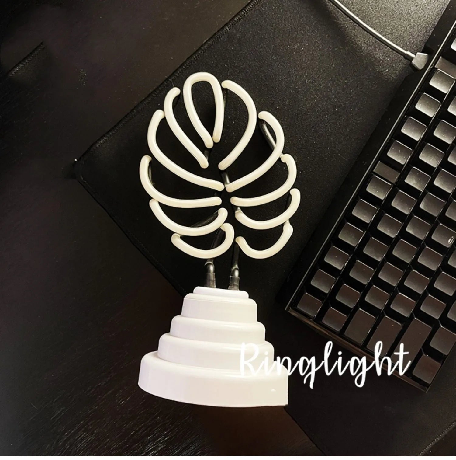 Minimalist bamboo-shaped white and green desktop lamp with USB cable in two size options.
