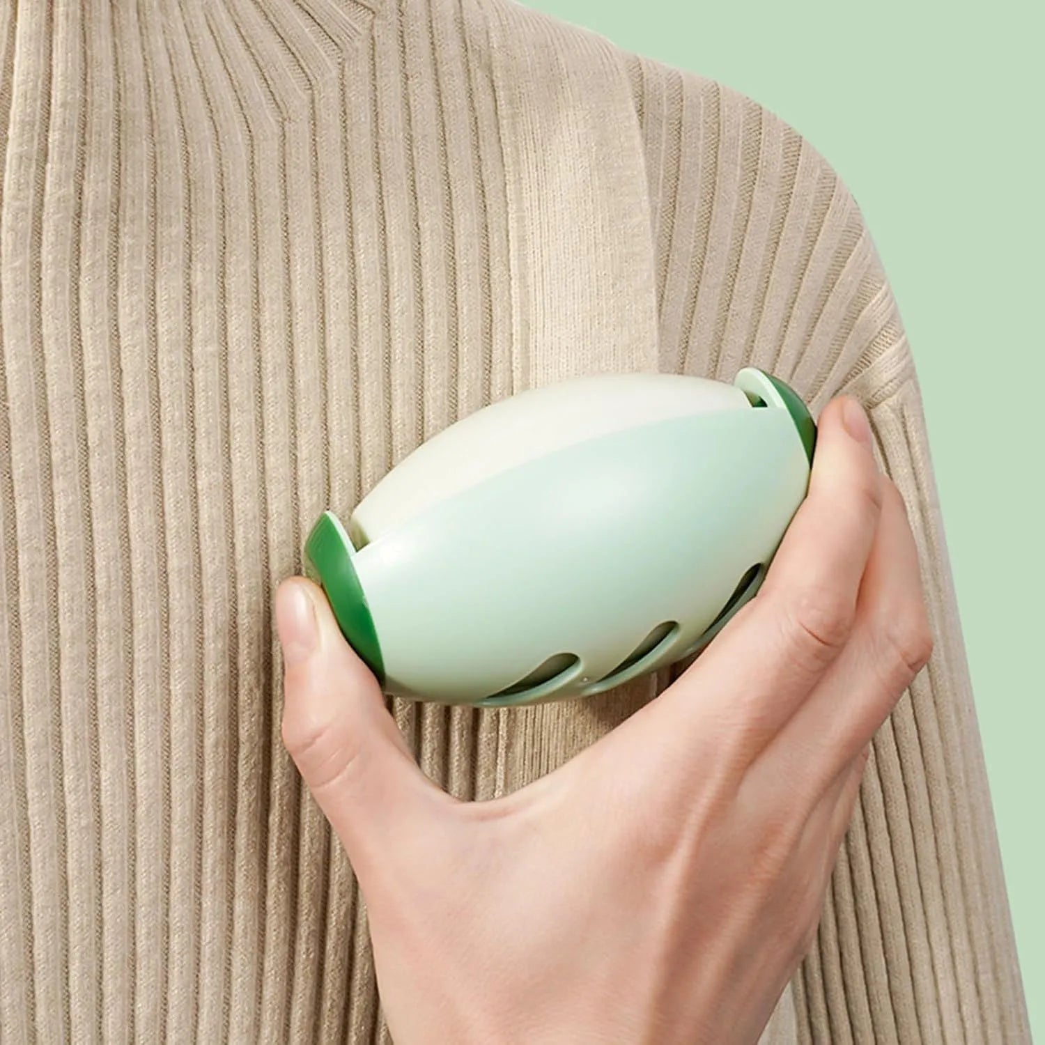 Green and white reusable gel lint roller ball for portable pet hair removal on clothing