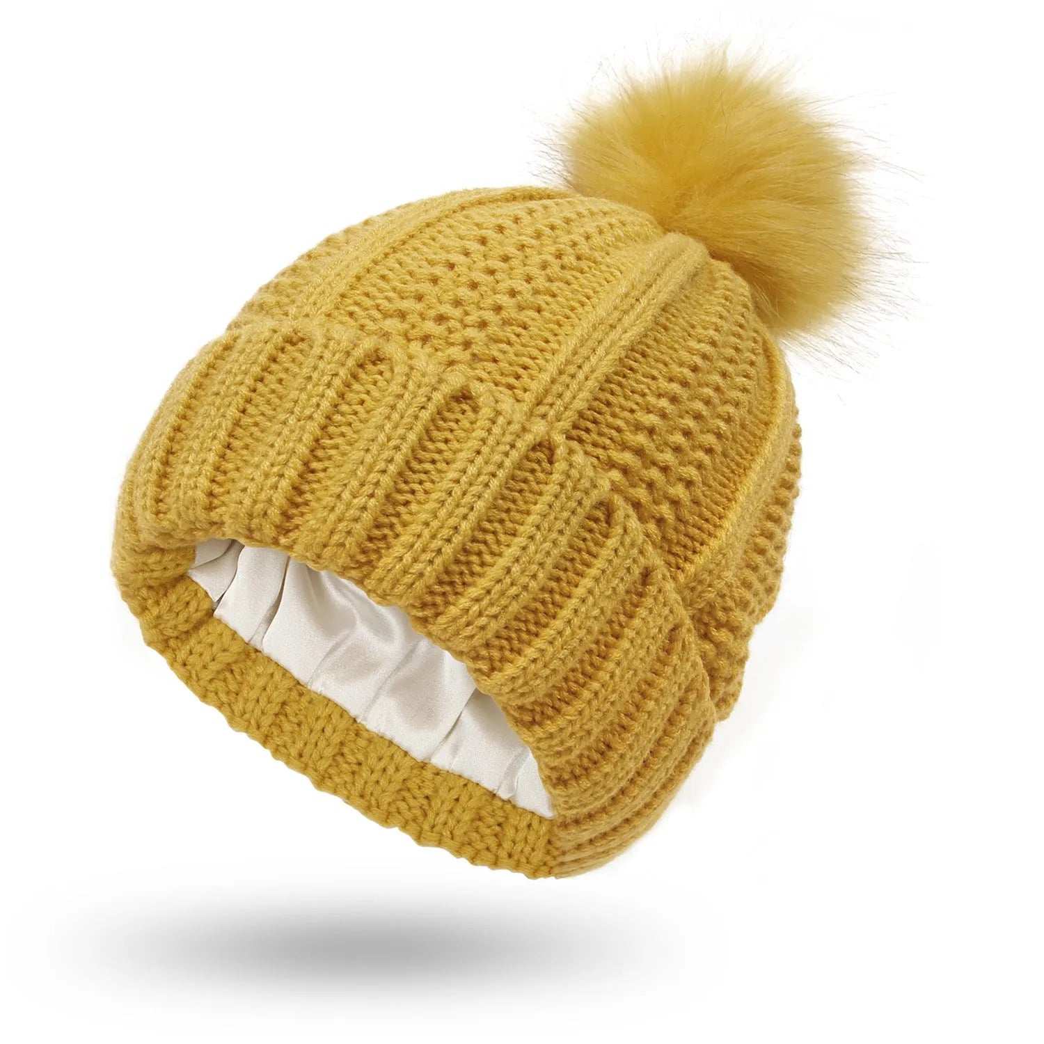 Women's black knit beanie with a faux fur pom pom and satin lining for hair protection