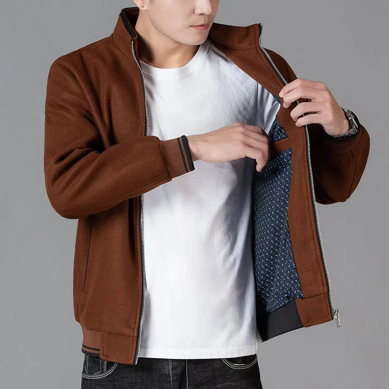 Men's grey polyester fleece jacket with long sleeves and a stick pocket, shown on a hanger.