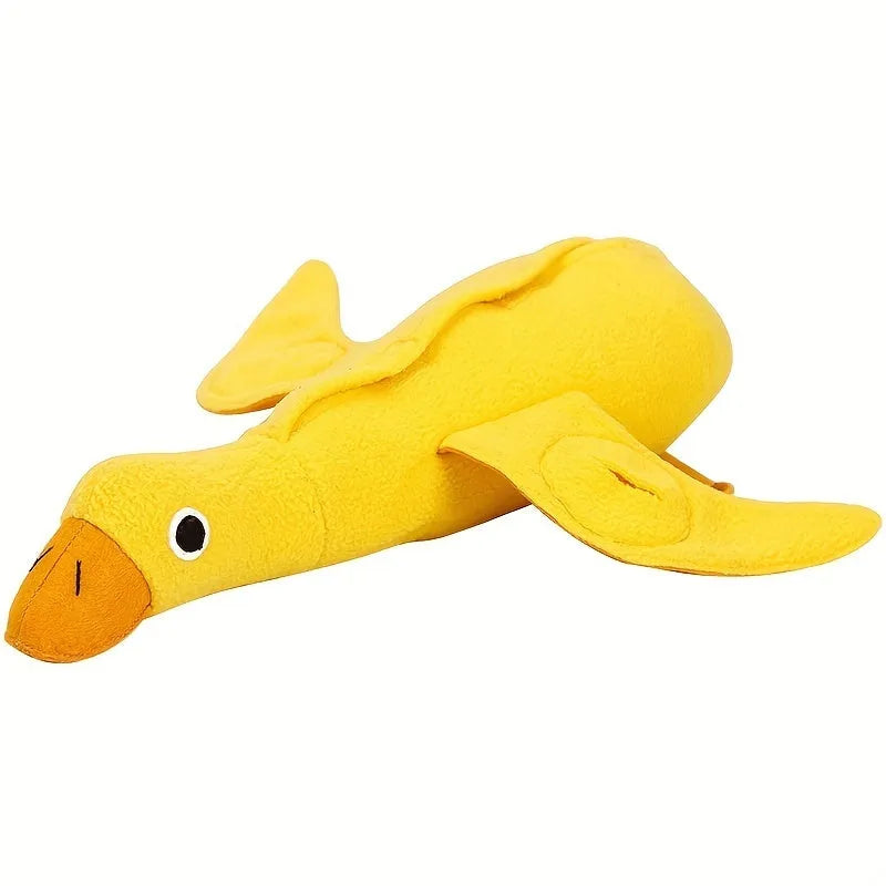 Yellow plush teddy bear dog toy with a small duck doll attached, showing food dispensing holes.