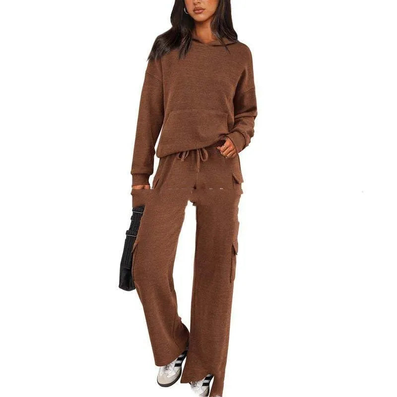 Women's two-piece leisure sports suit in polyester, showing long sleeve top and trousers in a solid colour.