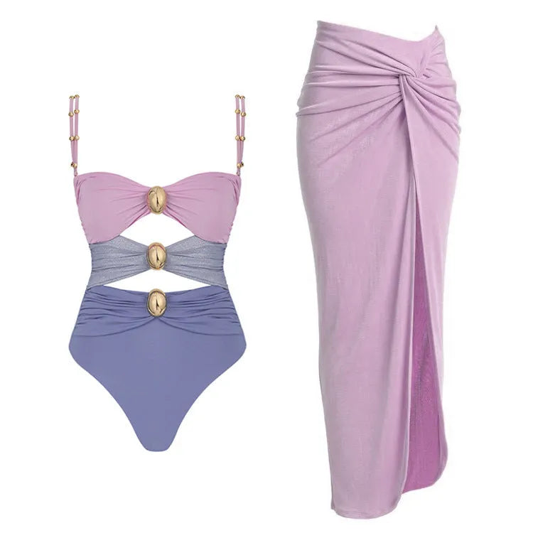 Women's solid-colour one-piece swimsuit with gold button and matching skirt in assorted colours.