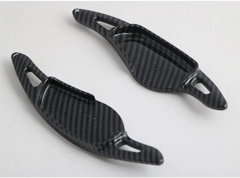 Steering wheel paddle shifter modification kit with carbon fibre pattern on black background
