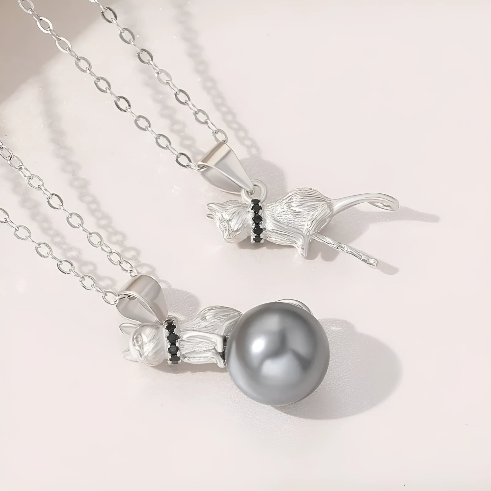Sterling silver cat pendant necklace on a chain, showing elegant clavicle-length design.