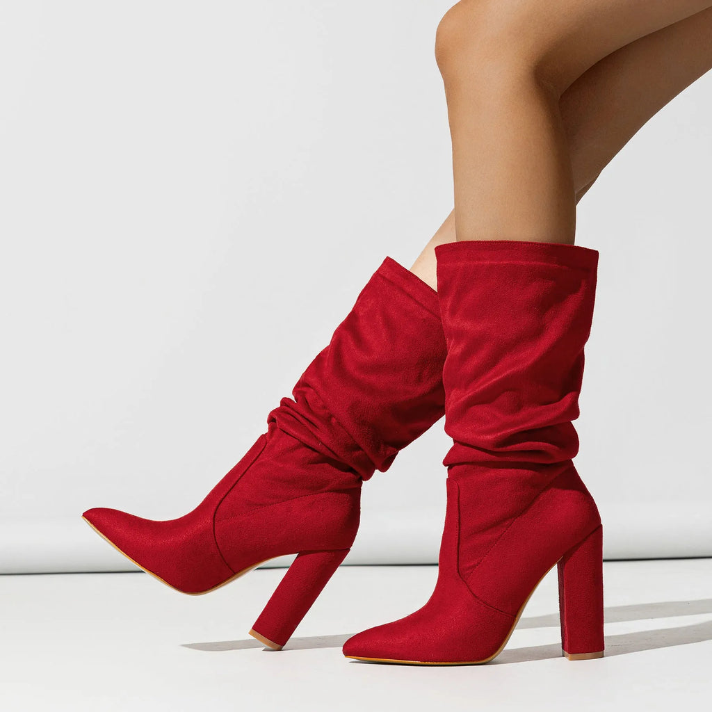 Women's black suede chunky heel pointed-toe boots with a high heel above 8cm and calf-length socks.