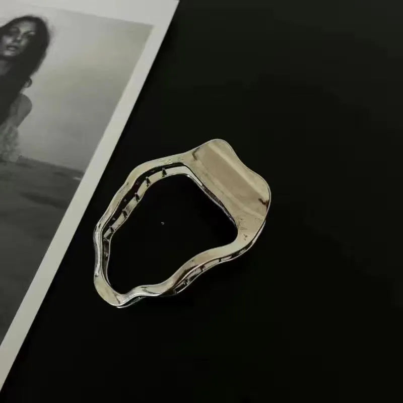 Golden zinc alloy hair barrette in an arc shape on a white background