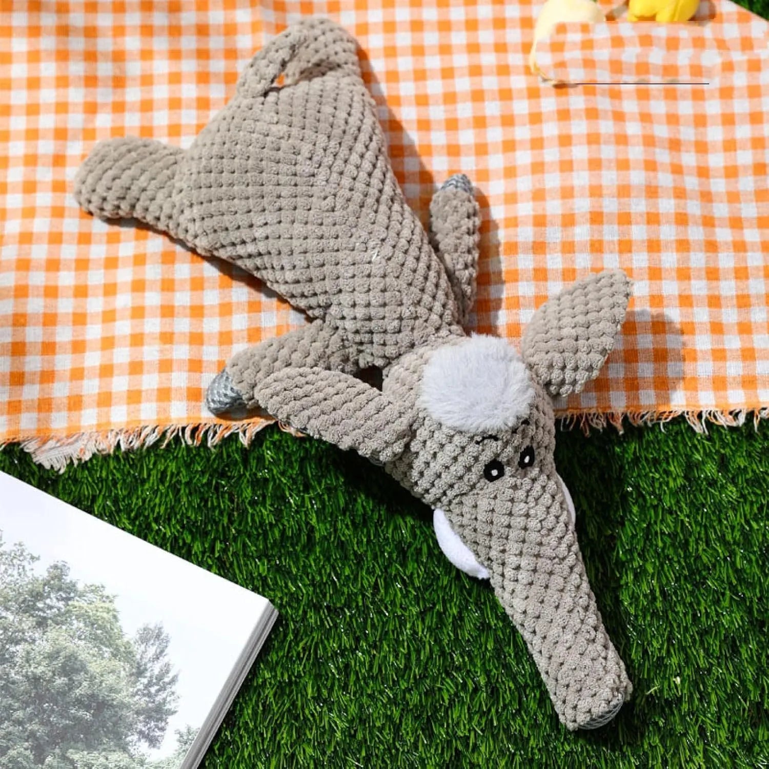 Interactive plush dog chew toy with corn kernel texture and squeaker in grey colour.
