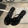 Women's rubber stiletto flip-flop sandals in black and camel colours on a white background.