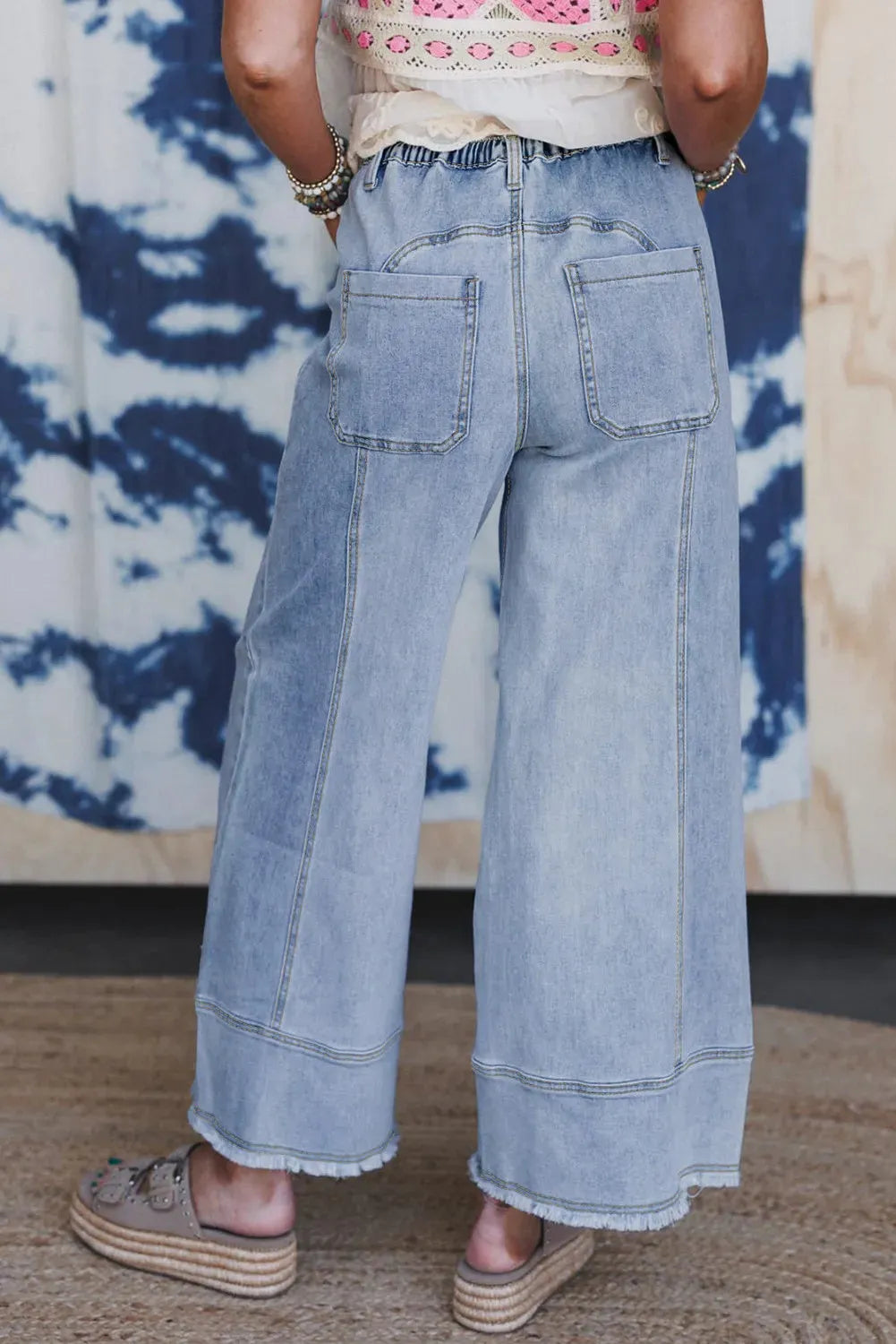 Beau Blue wide leg denim pants with drawstring waist and raw hem detailing laid flat