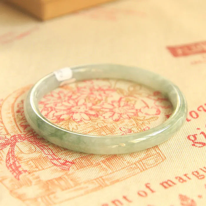 Green waxy jade geometric bracelet with Chinese-style design showing handmade construction