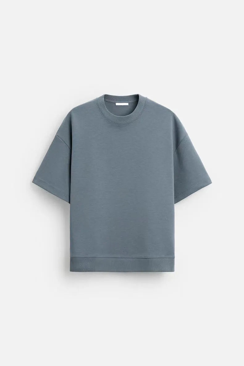 Loose blue polyester T-shirt and matching shorts set on a hanger, showing round neck and double-sided texture.