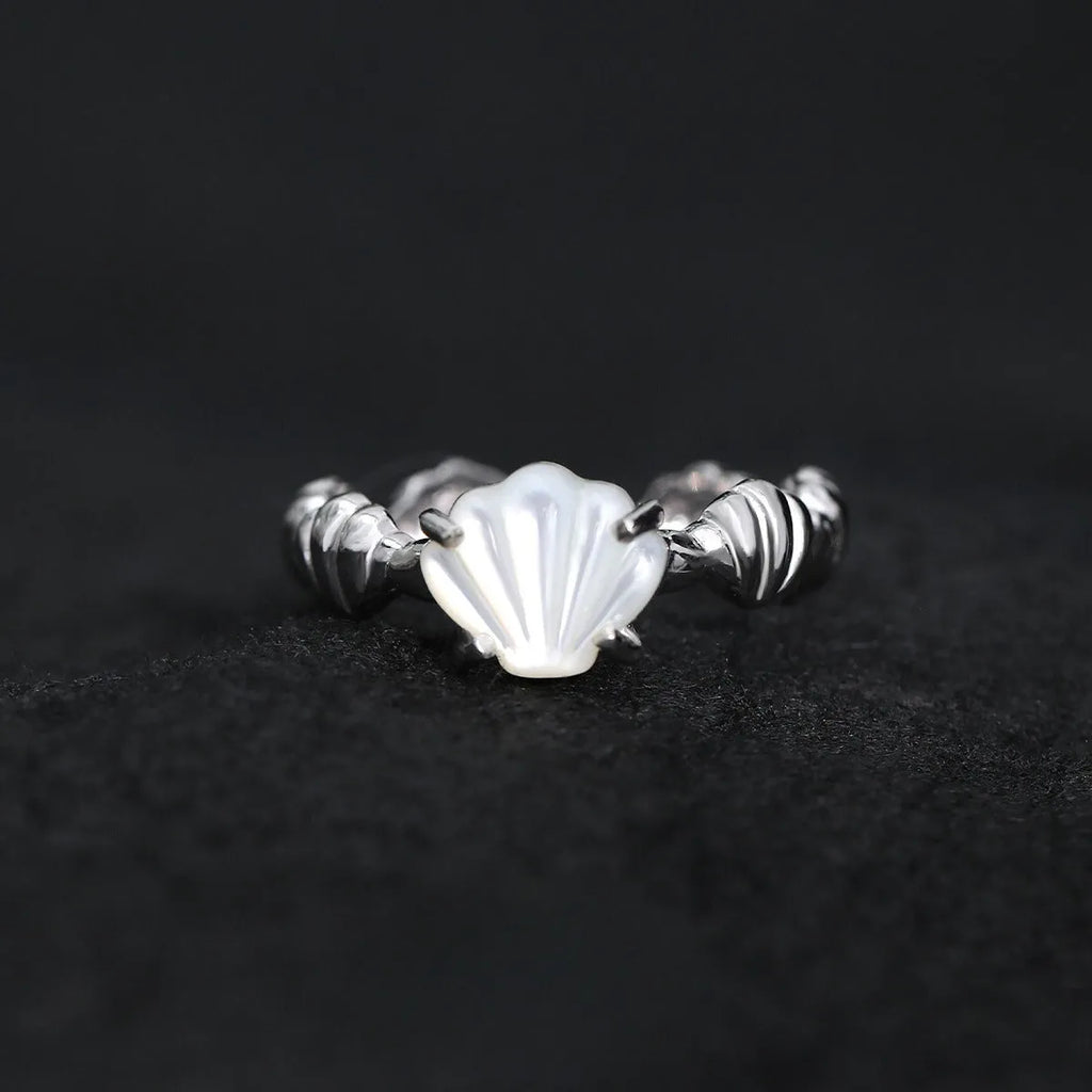 Silver adjustable ring with a tiger eye shell design and gold electroplated finish.