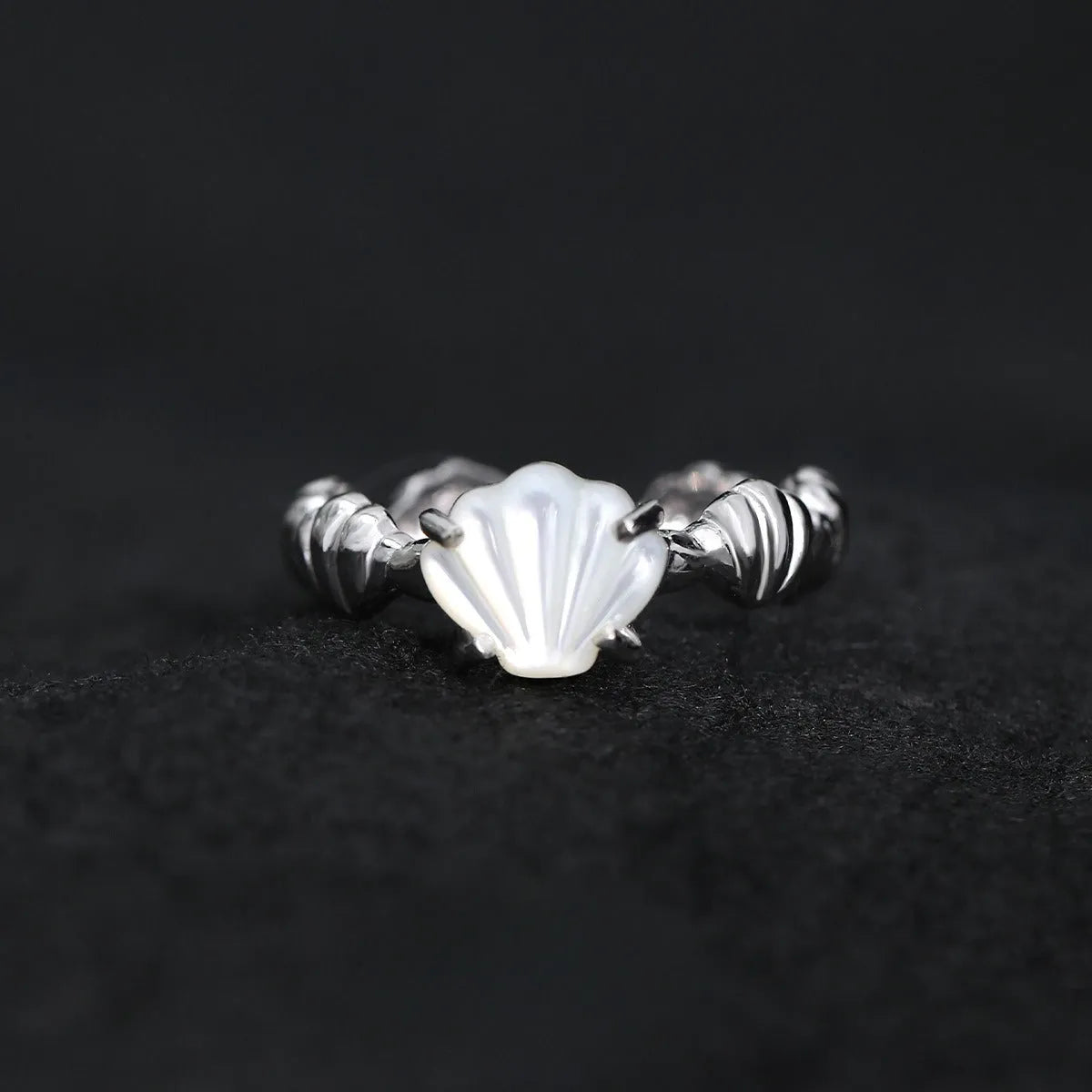 Silver adjustable ring with a tiger eye shell design and gold electroplated finish.
