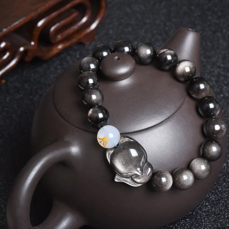 Natural obsidian stone bracelet with 10mm beads shown in gold, silver, and plain black style variations.