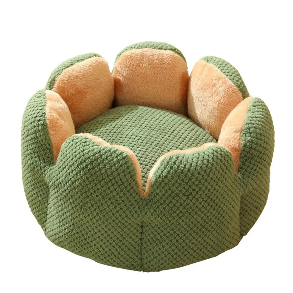Green cactus petal shaped plush dog bed with a non-slip bottom on a wooden floor.
