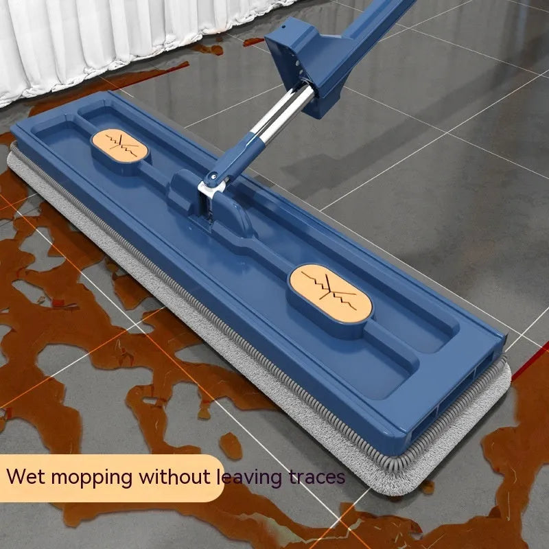 Large flat mop with blue cloth on a wooden floor, showing its 360-degree rotating head and long stainless steel handle.