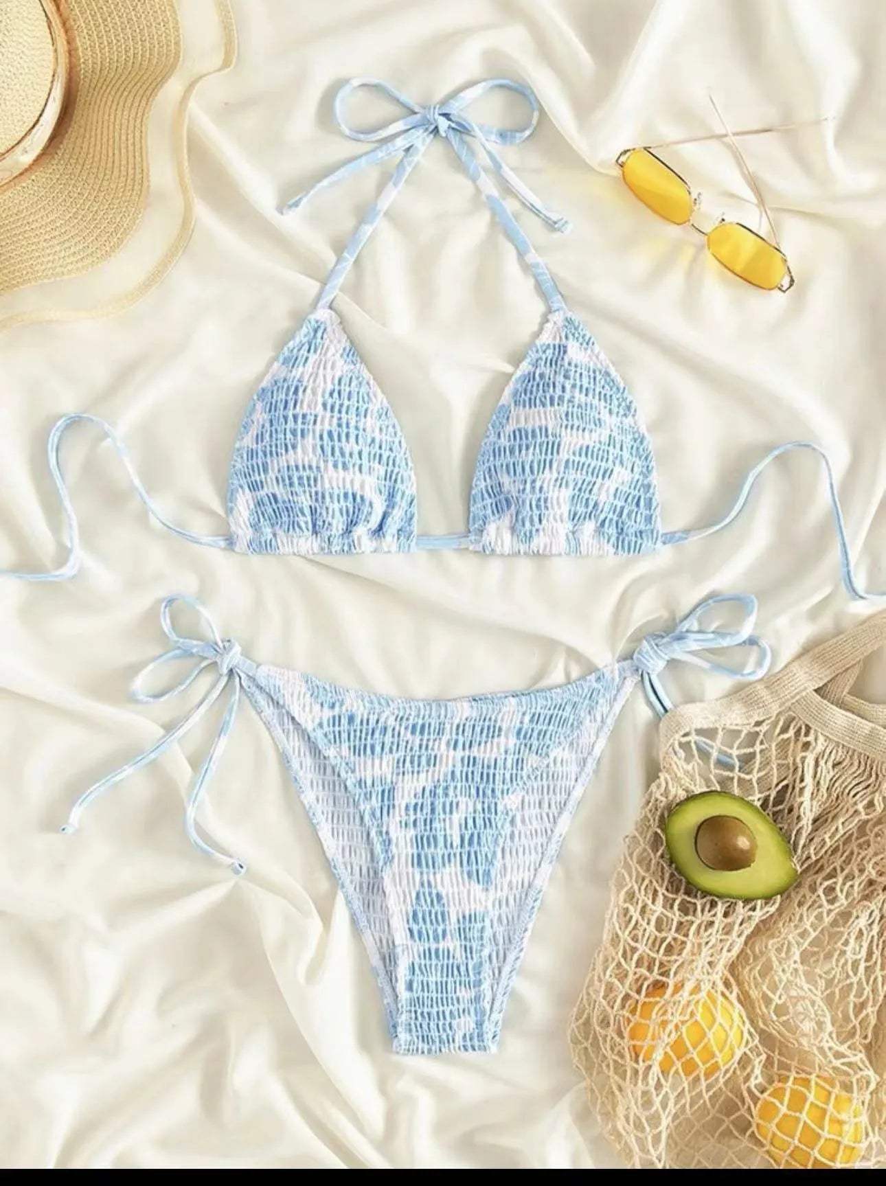 Women's floral print halter neck swimsuit briefs in light blue on a mannequin.