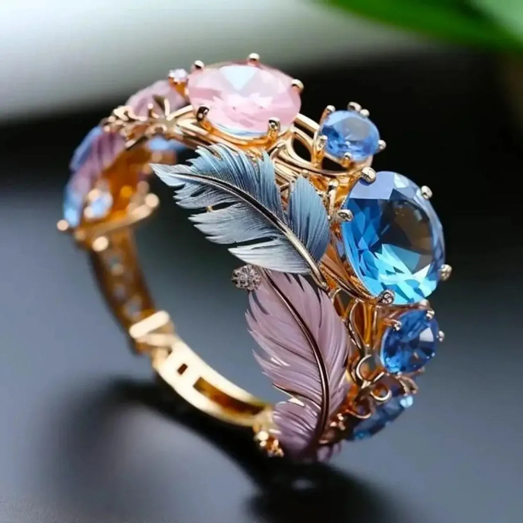 Gold colour brass ring with embossed feather design and sparkling zircon stone accents