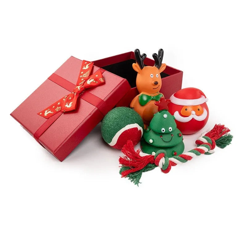 Seven Christmas gift bags containing vinyl dog toys with Santa heads, trees and deer figures