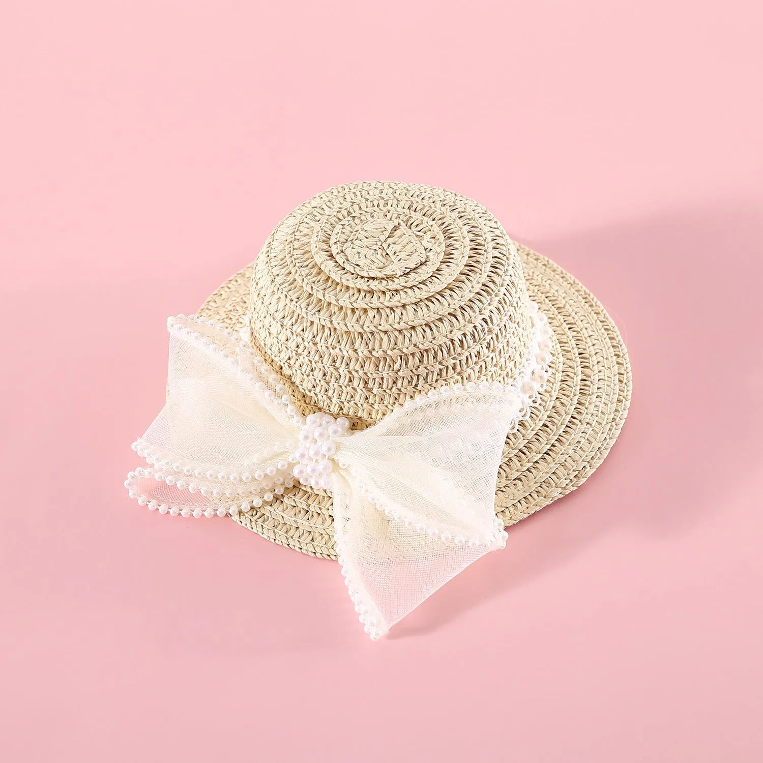 A woven Lafite leaf straw hat for a cat, decorated with a pearl butterfly bow, shown in pink, purple, blue, and white colour options.