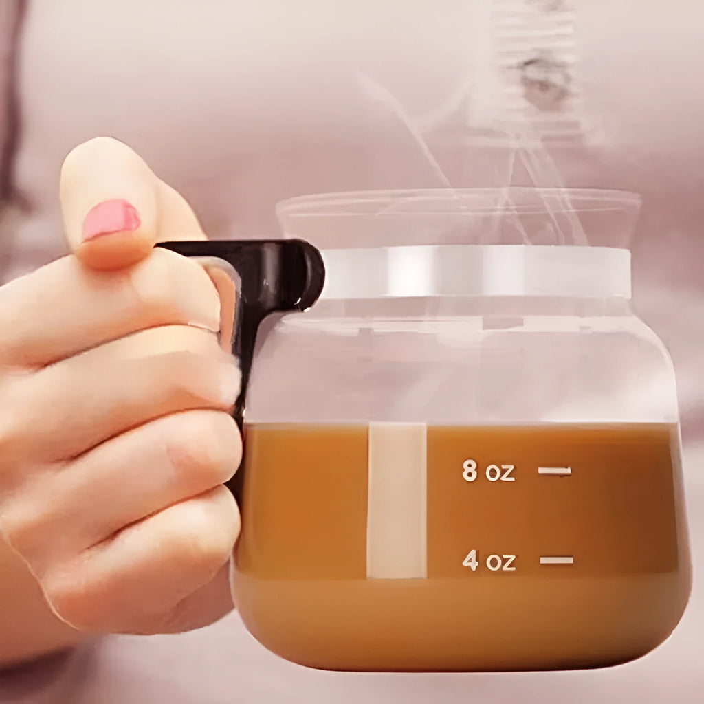 Transparent borosilicate glass coffee maker with black silicone cover on a kitchen counter