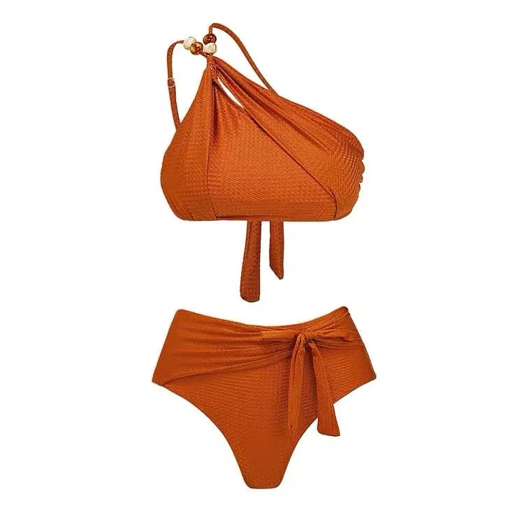 Brown high waist bikini with padded halter top and a sheer black chiffon overdress on a mannequin.
