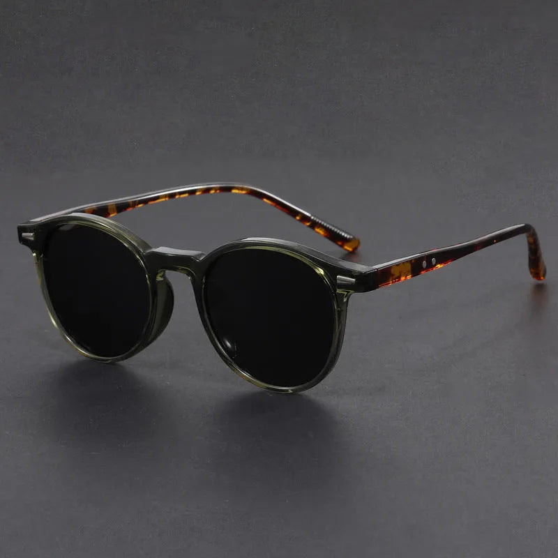 Retro oval sunglasses with ultra-lightweight round frame and polarised grey lenses.