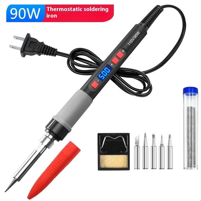 Grey 90W electric soldering iron kit with ceramic heating core, five tips, sponge, and tin wire on workbench