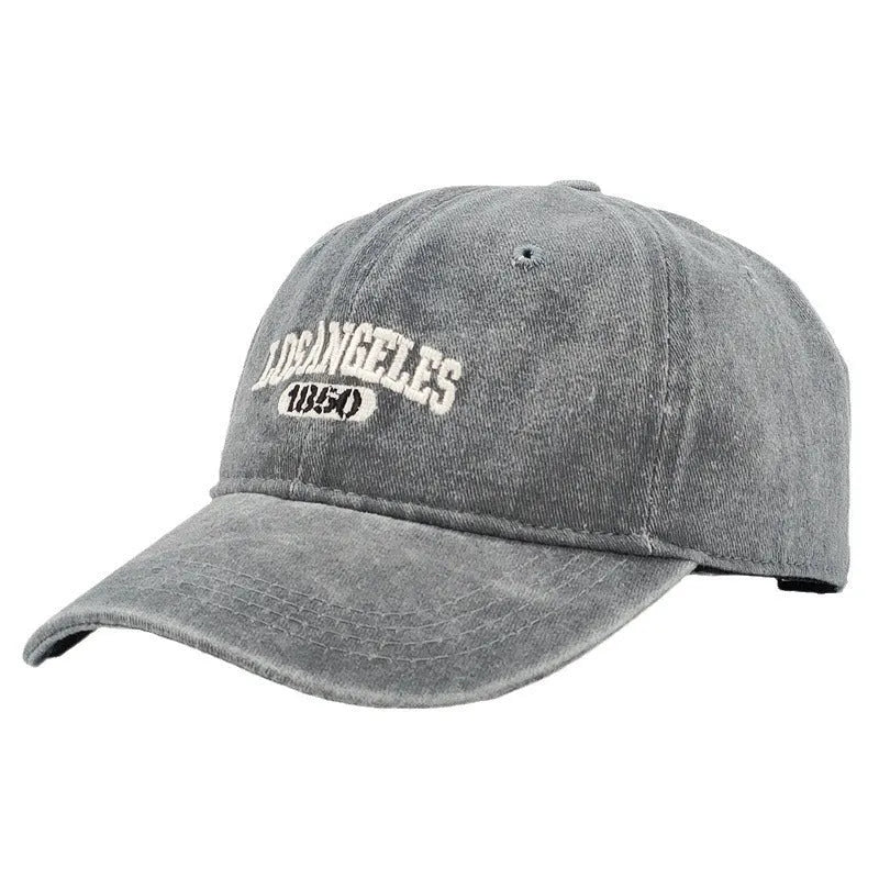 Adult personalised embroidered peaked cap in beige with adjustable strap and distressed lettering.
