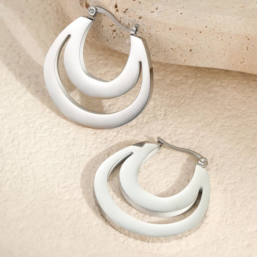 Geometric French hook earrings with round design in gold and steel metallic finishes