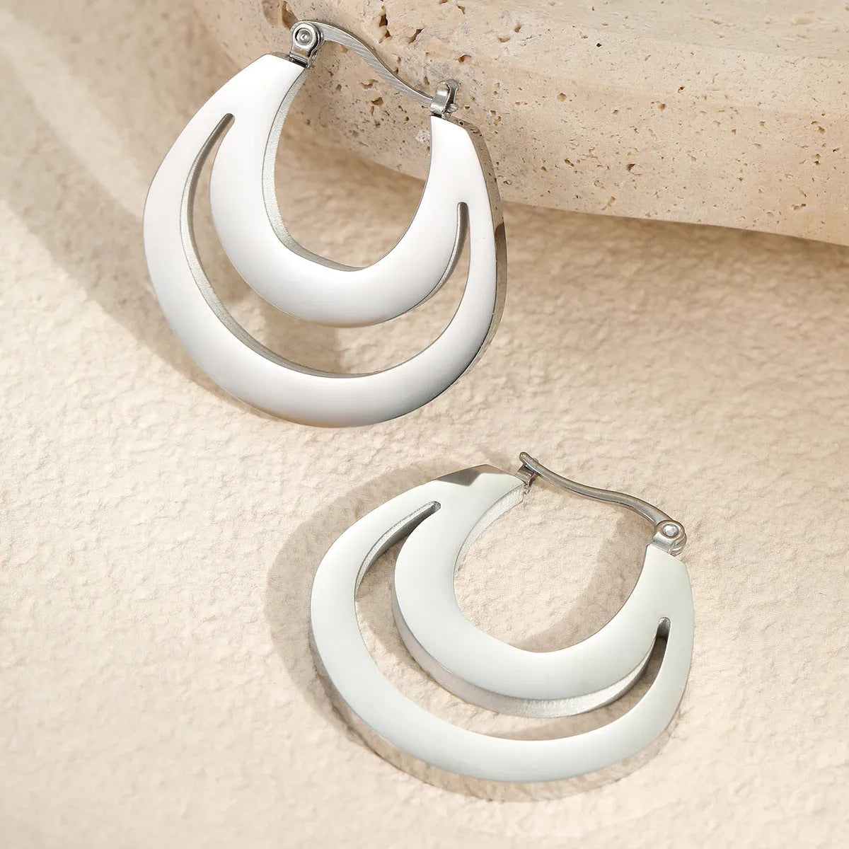 Geometric French hook earrings with round design in gold and steel metallic finishes