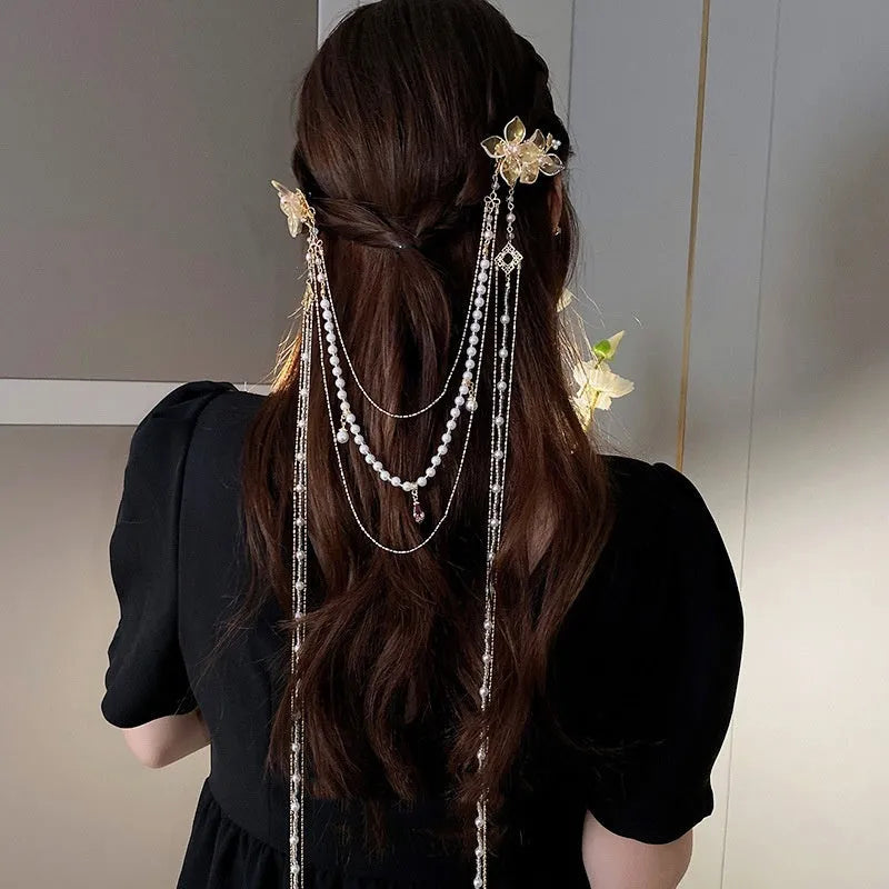 Gold women's hairpin with pearl, diamond acrylic details and a long tassel.