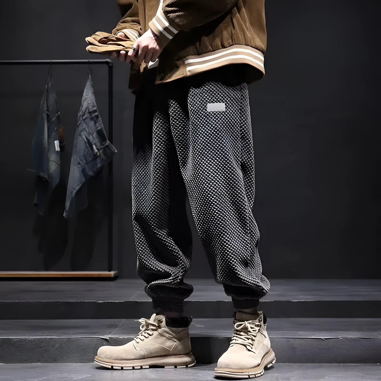 Men's grey straight-leg sweatpants with ankle ties on a plain background.