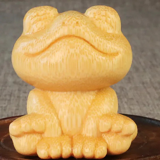 Solid bamboo carving ornament of smiling frog design measuring 5cm height and 4.5cm diameter